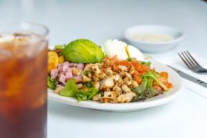 Fresh Cobb Salad with chicken, bacon, eggs, and avocado at Tasty Munch.