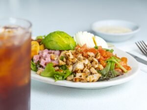 Fresh Cobb Salad with chicken, bacon, eggs, and avocado at Tasty Munch.