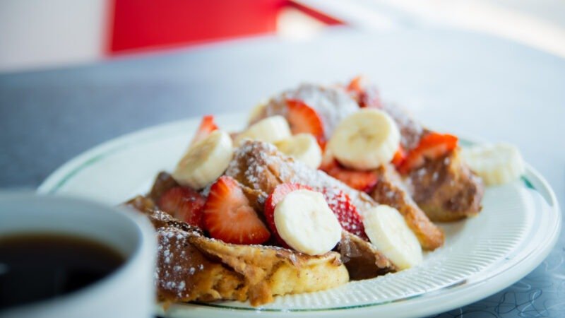 Golden French Toast dusted with powdered sugar at Tasty Munch.