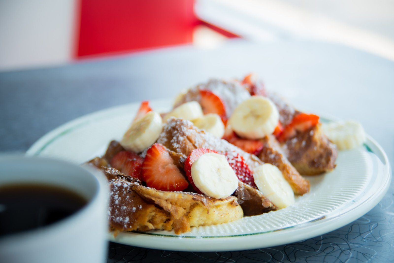 Golden French Toast dusted with powdered sugar at Tasty Munch.