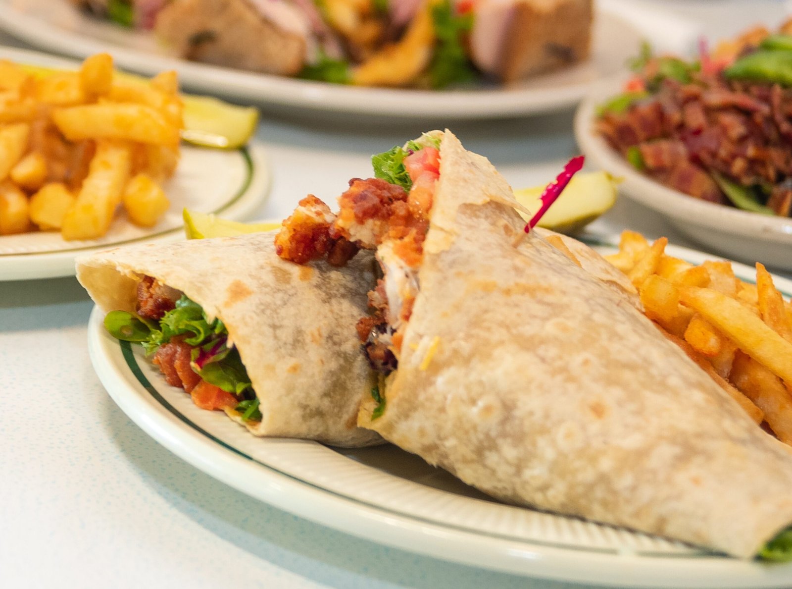 Buffalo Chicken Wrap with shredded lettuce, diced chicken in buffalo sauce, tomatoes, cheddar and jack cheese, and ranch dressing at Tasty Munch.