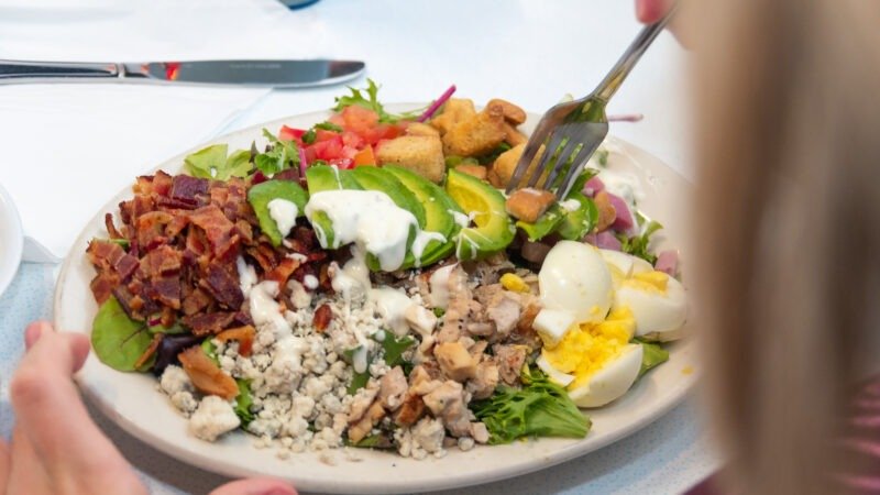 Fresh Cobb Salad with chicken, bacon, eggs, and avocado at Tasty Munch.