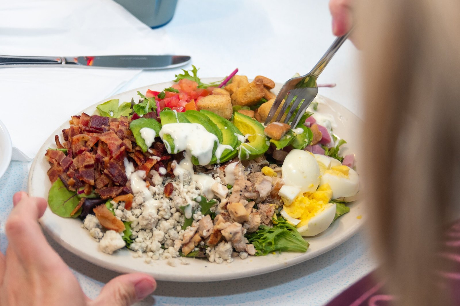 Fresh Cobb Salad with chicken, bacon, eggs, and avocado at Tasty Munch.