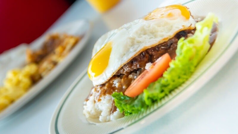 Hawaiian-style Loco Moco breakfast with rice, hamburger patty, fried egg, and gravy at Tasty Munch in Houston