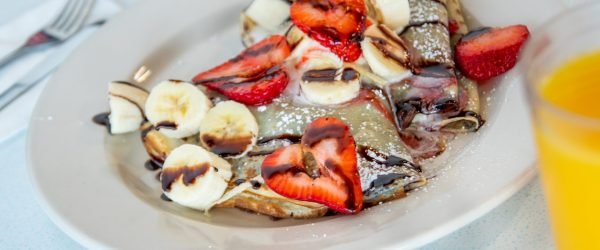 Crepes with cream cheese, strawberries, and syrup at Tasty Munch.